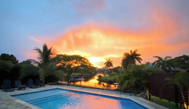 Waterfront ranch home near Siesta Key with pool overlooking canal and kayaks.